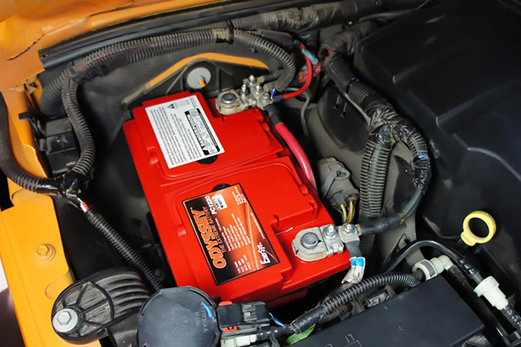 Mechanic performing a Jeep Wrangler battery replacement process in a convenient location